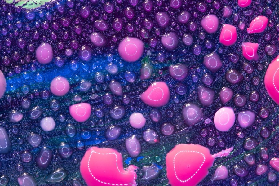 Detailed close-up of a large paint bubble on a ceiling, showing the raised, cracked surface.
