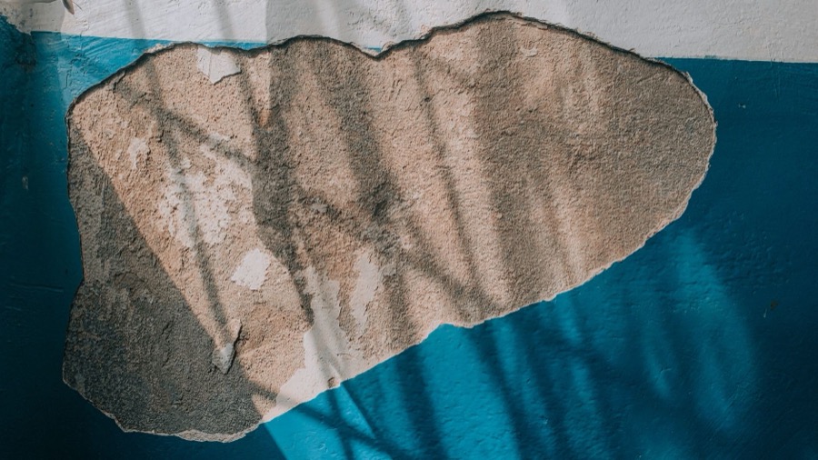 Detailed view of a damp or stained interior wall showing water damage, a common cause of bubbling paint.